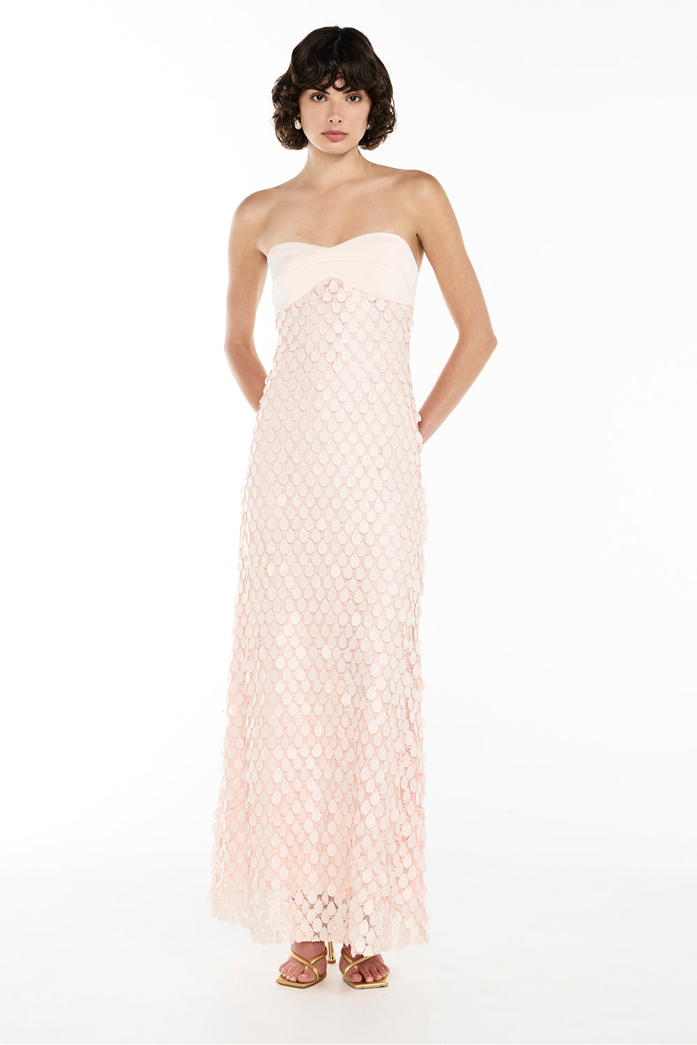 Woman wearing pink strapless textured dress with petal detail